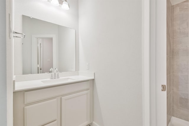 bathroom featuring vanity and a tile shower