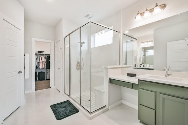 bathroom with vanity, a wealth of natural light, and a shower with door