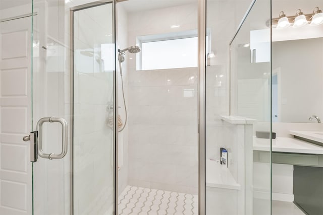 bathroom with a shower with door and vanity