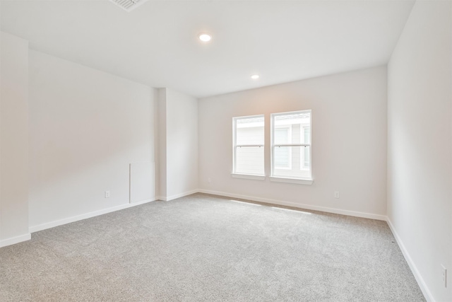 spare room with light colored carpet