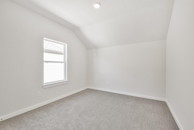 bonus room featuring lofted ceiling and carpet