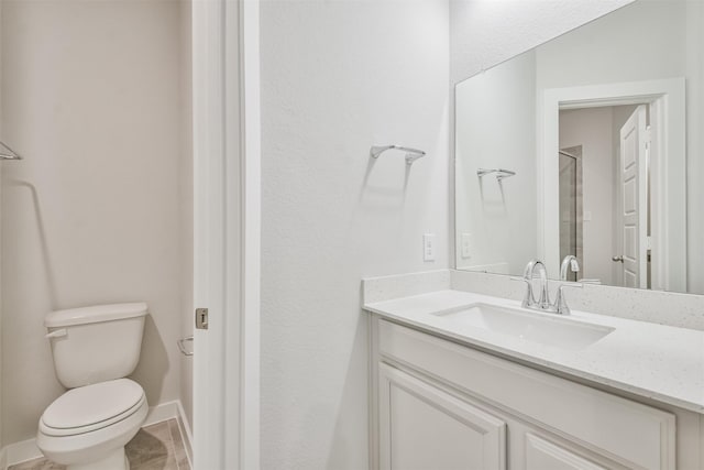 bathroom featuring an enclosed shower, vanity, tile patterned floors, and toilet