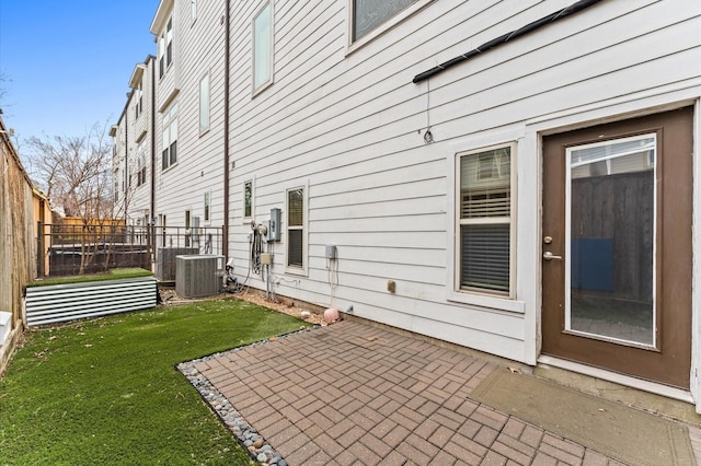 exterior space with a yard, a patio, and central air condition unit