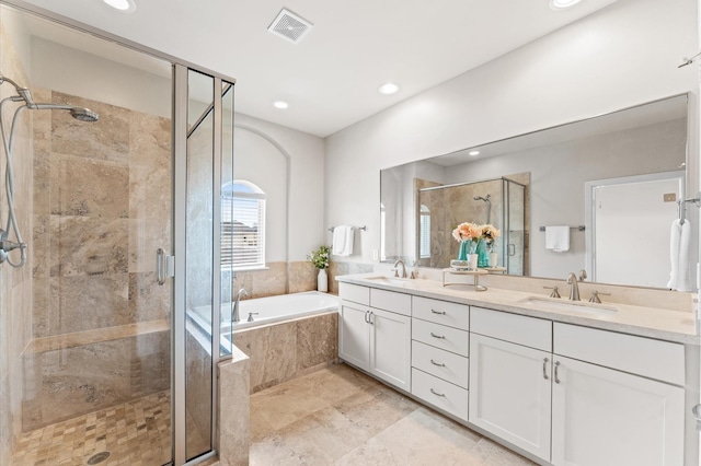 bathroom featuring vanity and separate shower and tub