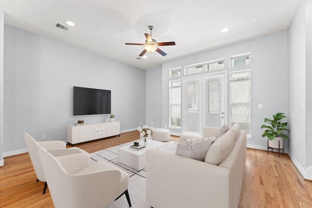 living room with ceiling fan, light wood-type flooring, and french doors