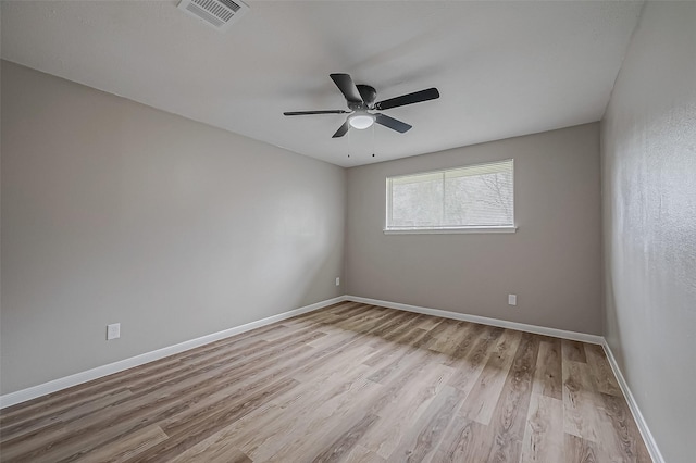 spare room with ceiling fan and light wood-type flooring