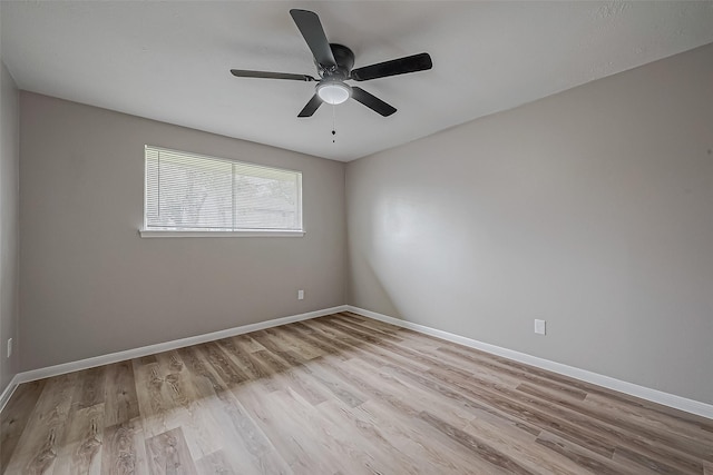 spare room featuring light hardwood / wood-style floors and ceiling fan