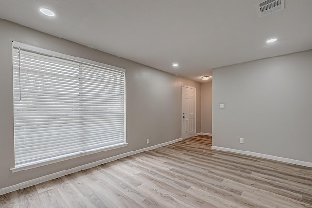 unfurnished room with light hardwood / wood-style floors