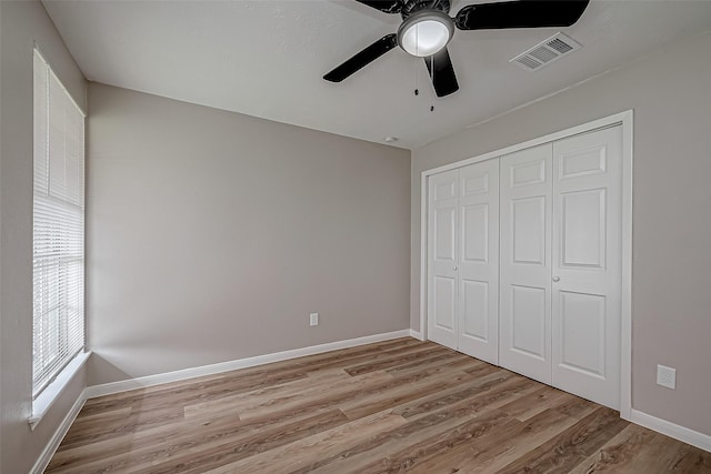 unfurnished bedroom featuring ceiling fan, a closet, and light hardwood / wood-style flooring