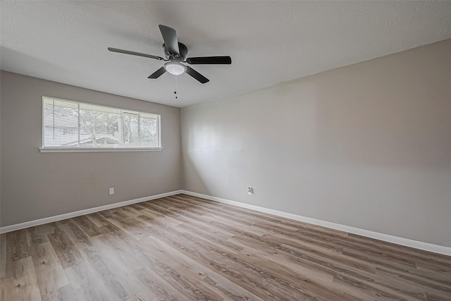 unfurnished room featuring ceiling fan, light hardwood / wood-style floors, and a textured ceiling