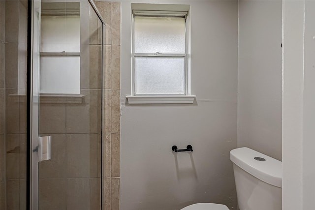 bathroom featuring toilet and walk in shower