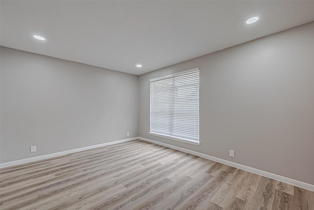 unfurnished room with light hardwood / wood-style floors