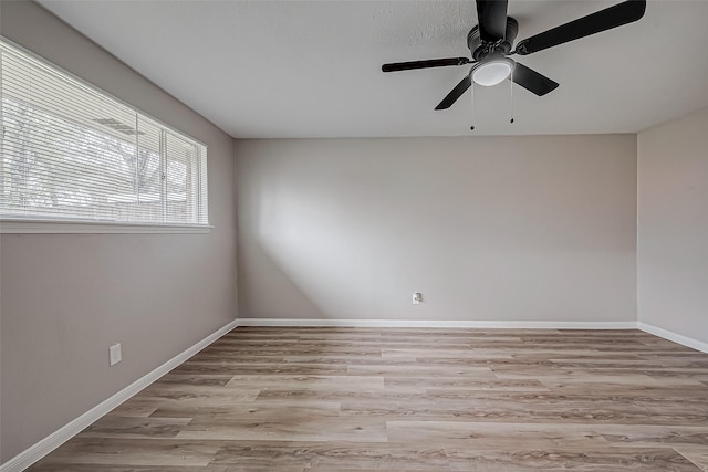 unfurnished room featuring ceiling fan and light wood-type flooring