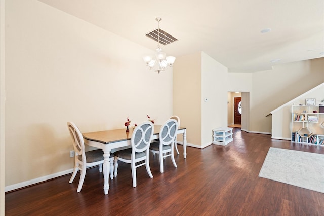 dining room featuring a notable chandelier and dark wood-type flooring