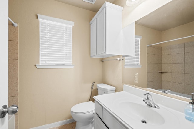 bathroom featuring walk in shower, tile patterned floors, vanity, and toilet