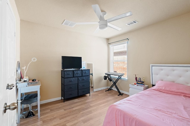 bedroom with ceiling fan and light hardwood / wood-style floors