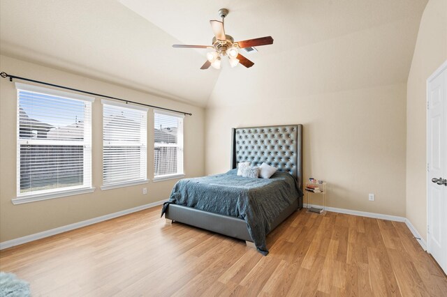 bedroom featuring ceiling fan, lofted ceiling, and light wood-type flooring