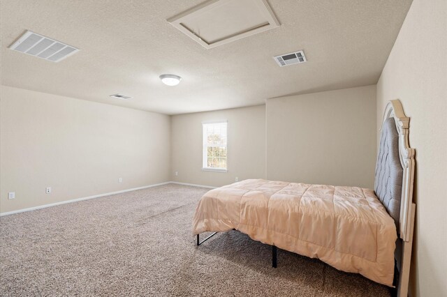 bedroom with carpet and a textured ceiling