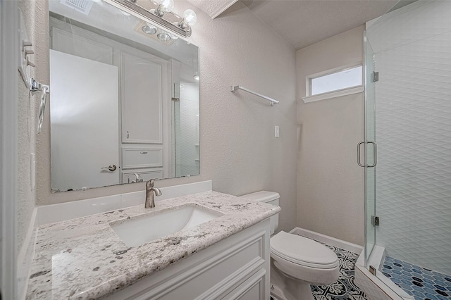 bathroom with vanity, toilet, and an enclosed shower