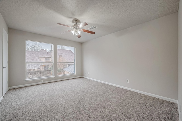 carpeted empty room with a textured ceiling and ceiling fan