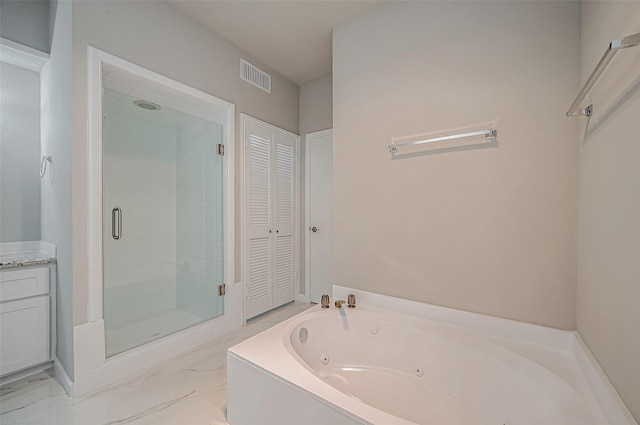 bathroom with vanity and shower with separate bathtub