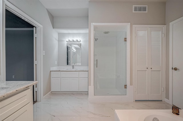 bathroom featuring vanity and a shower with shower door