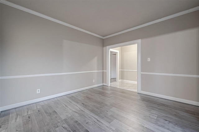 unfurnished room featuring crown molding and light hardwood / wood-style flooring