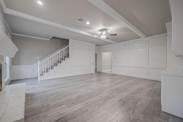 unfurnished living room featuring ceiling fan, crown molding, and light hardwood / wood-style floors