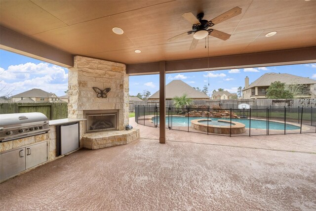 18007 Stari Most Ln, Houston, TX 77044 - view of patio featuring area for grilling, an outdoor stone fireplace, a fenced backyard, and a pool with connected hot tub