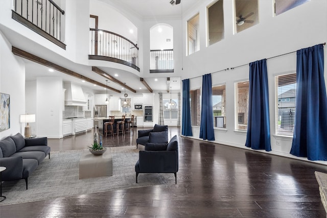 18007 Stari Most Ln, Houston, TX 77044 - living room featuring dark wood finished floors, ceiling fan, recessed lighting, a high ceiling, and a chandelier