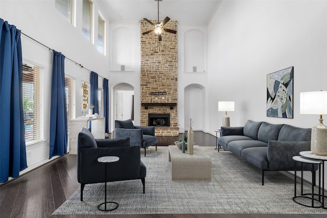 18007 Stari Most Ln, Houston, TX 77044 - living area with a high ceiling, a ceiling fan, wood finished floors, a fireplace, and arched walkways