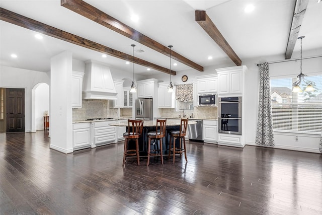 18007 Stari Most Ln, Houston, TX 77044 - kitchen featuring appliances with stainless steel finishes, custom range hood, decorative backsplash, a kitchen bar, and beam ceiling