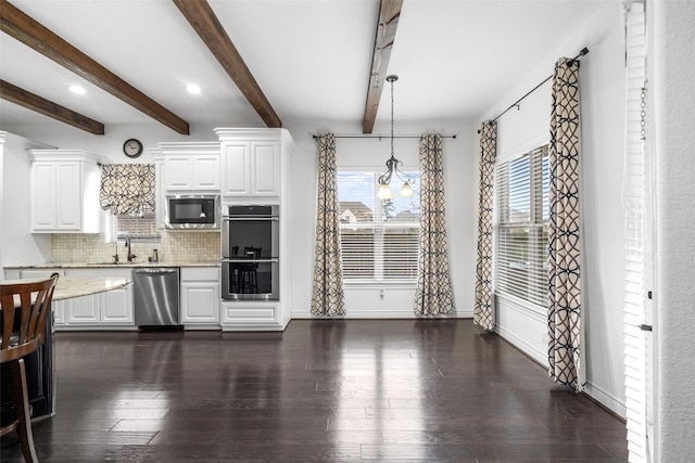 18007 Stari Most Ln, Houston, TX 77044 - kitchen with stainless steel appliances, backsplash, a sink, white cabinets, and beam ceiling