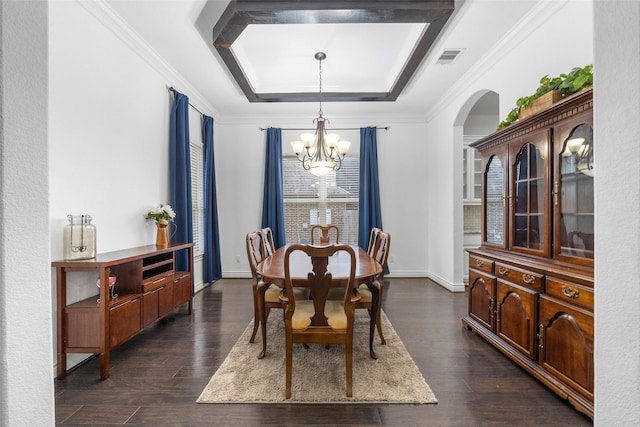 18007 Stari Most Ln, Houston, TX 77044 - dining space featuring a chandelier, a tray ceiling, arched walkways, dark wood-type flooring, and crown molding