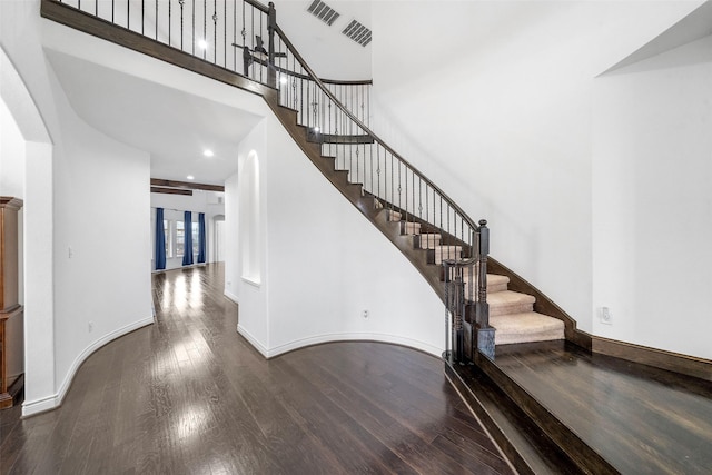 18007 Stari Most Ln, Houston, TX 77044 - staircase with wood finished floors, arched walkways, baseboards, a towering ceiling, and french doors