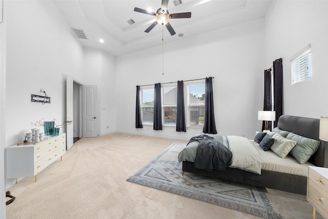 18007 Stari Most Ln, Houston, TX 77044 - bedroom featuring a towering ceiling, light colored carpet, a tray ceiling, and ceiling fan