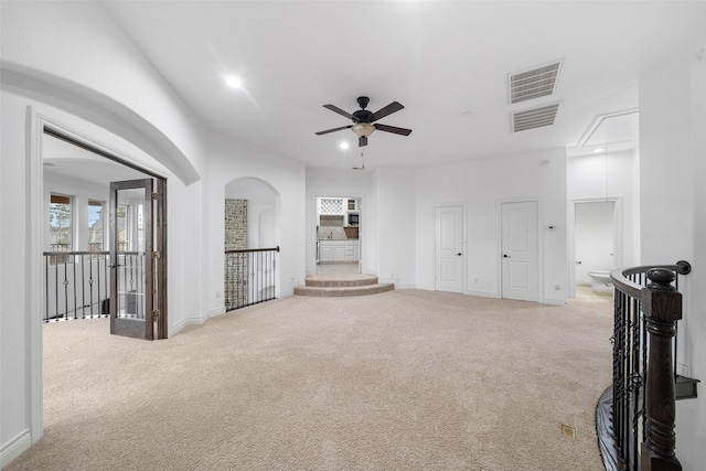 18007 Stari Most Ln, Houston, TX 77044 - unfurnished living room with attic access, carpet floors, a ceiling fan, arched walkways, and recessed lighting