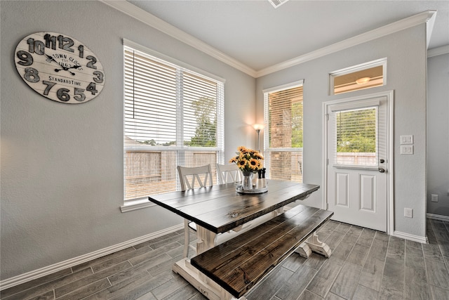 dining room featuring baseboards, a textured wall, ornamental molding, and wood tiled floor