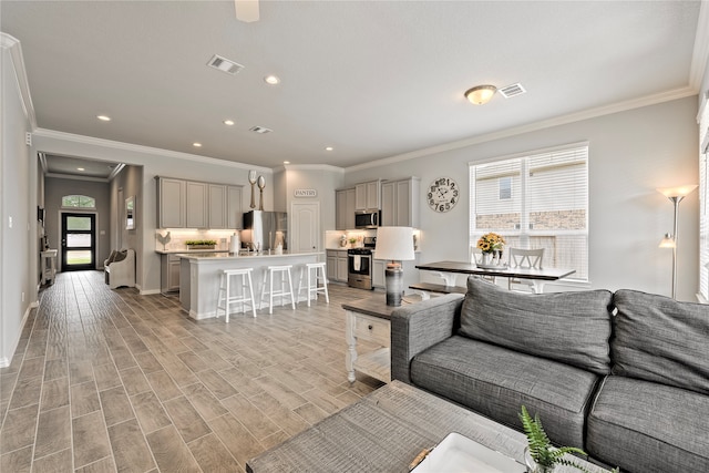 living room featuring light wood-type flooring, baseboards, visible vents, and recessed lighting