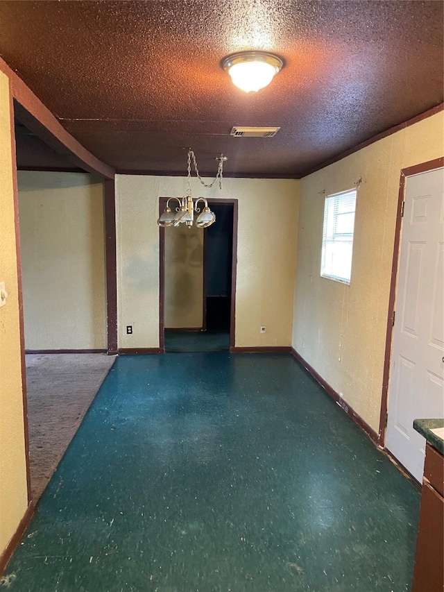 empty room featuring a textured ceiling