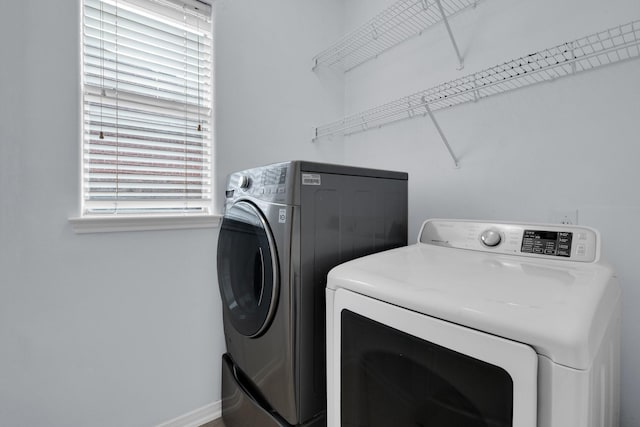 clothes washing area featuring washer and clothes dryer