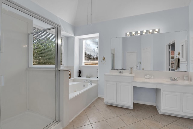 bathroom featuring independent shower and bath, vanity, vaulted ceiling, and tile patterned floors