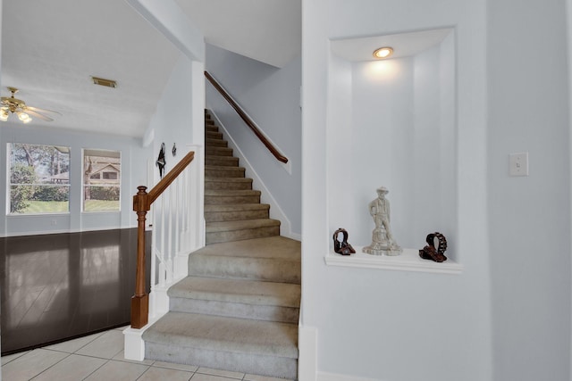 stairway with tile patterned floors