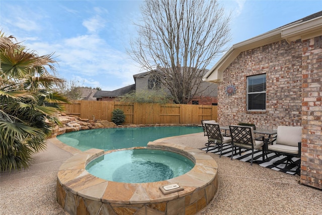 view of swimming pool with an in ground hot tub and a patio