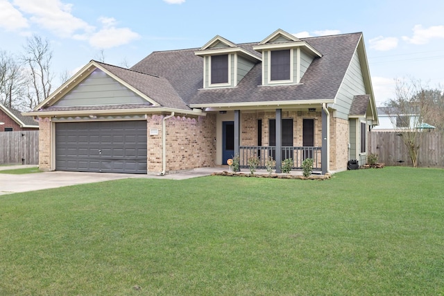 view of front of house with a garage, a front yard, and a porch