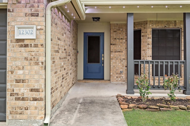 view of exterior entry with covered porch