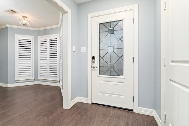 entryway with dark hardwood / wood-style flooring and crown molding