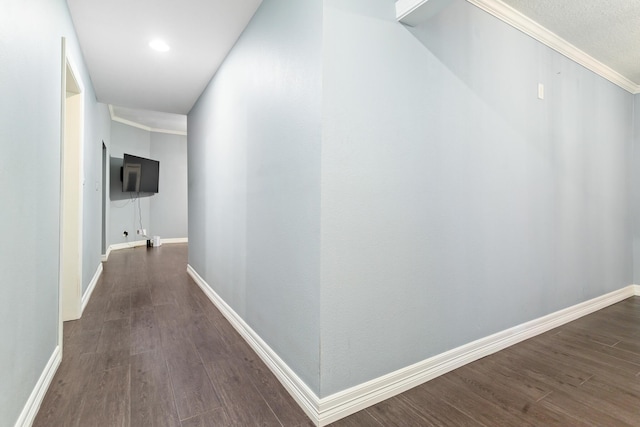 hallway with crown molding and dark hardwood / wood-style flooring