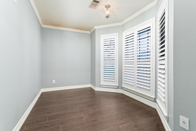 unfurnished room featuring ornamental molding and dark hardwood / wood-style flooring