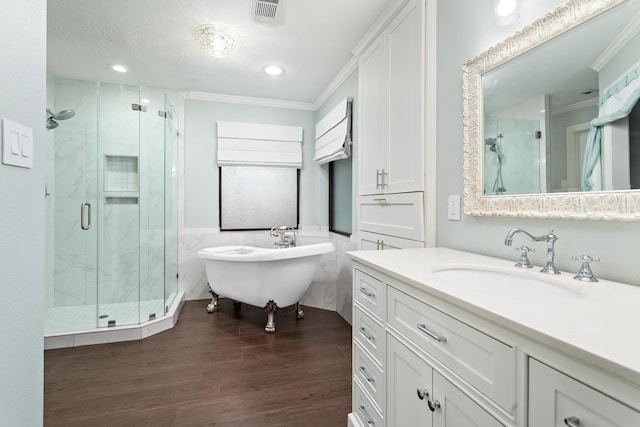 bathroom with crown molding, tile walls, vanity, wood-type flooring, and shower with separate bathtub